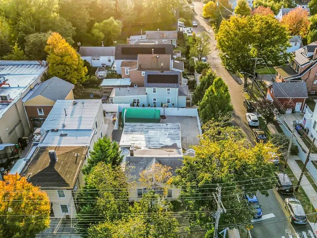 an aerial view of a house with a yard basket ball court and outdoor seating