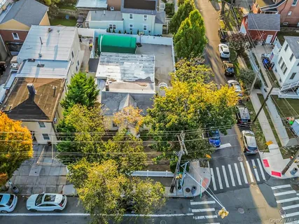 an aerial view of multiple houses with yard