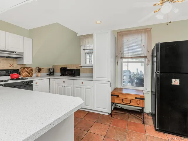 a kitchen with a refrigerator and a stove
