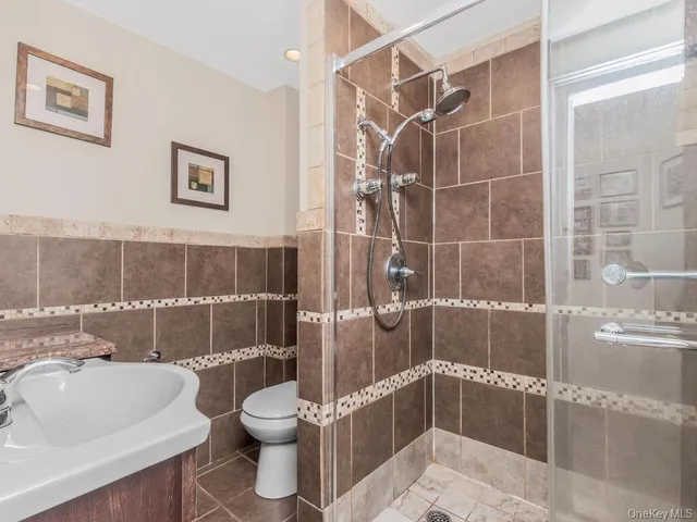 a bathroom with a toilet and a shower