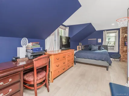 a bedroom with furniture and a dresser