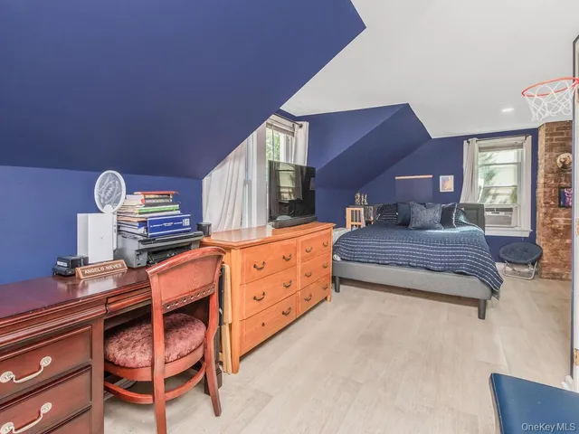 a bedroom with furniture and a dresser