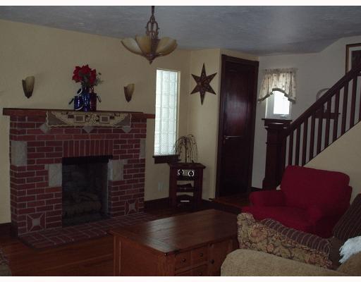 930 Ridge Road Ambridge, PA 15003 - Photo 6 of 16 Living Room. Living room with fireplace, hardwood floors. Also showing stairway and other original woodwork..
