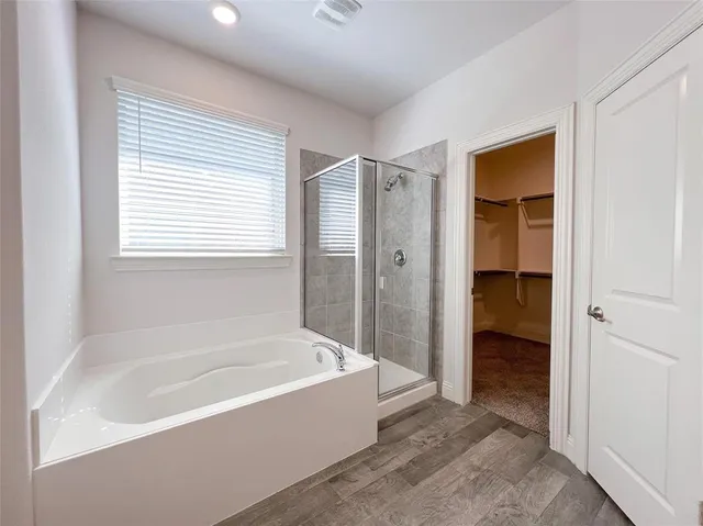 a bathroom with a bathtub and a shower