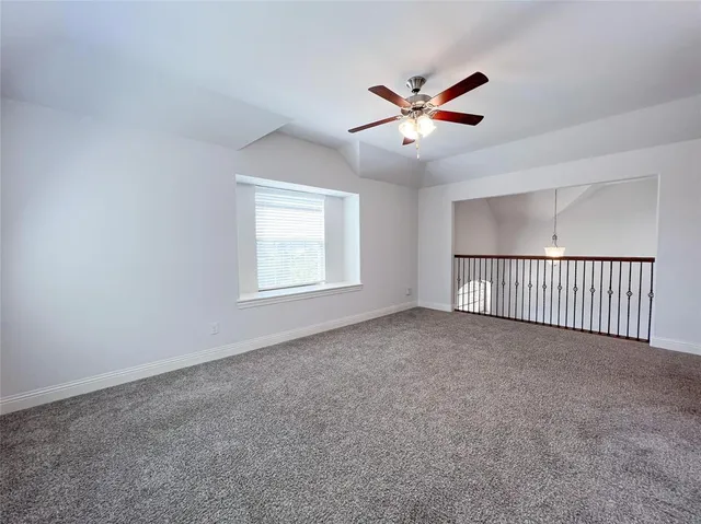 a view of a livingroom with a ceiling fan and window