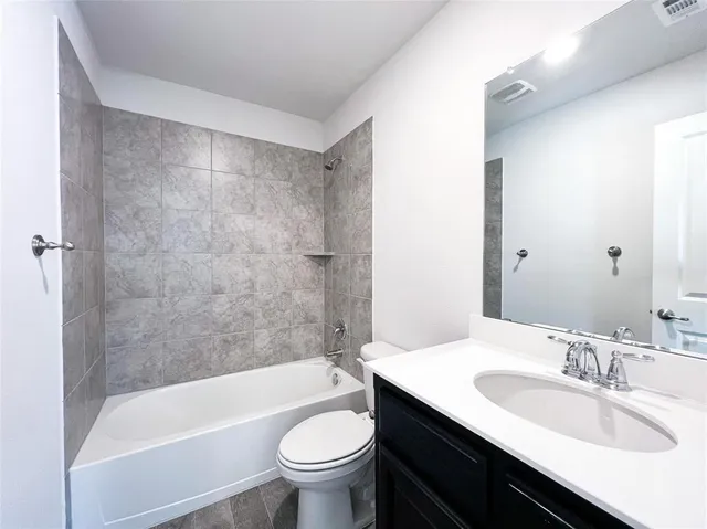 a bathroom with a sink a toilet and bathtub