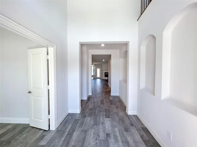 a view of a hallway with wooden floor