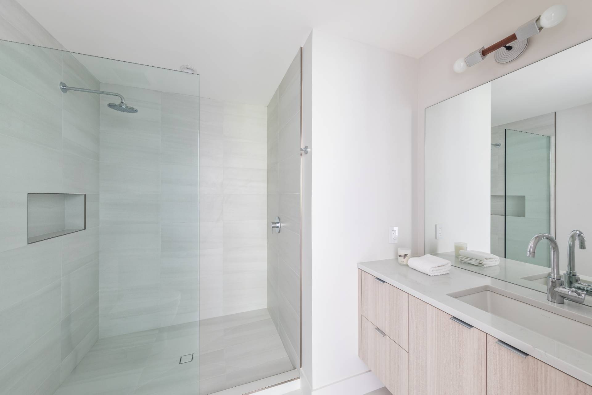 2 Semaphore Road East Hampton, NY 11937 - Photo 24 of 37 a bathroom with a shower sink and mirror