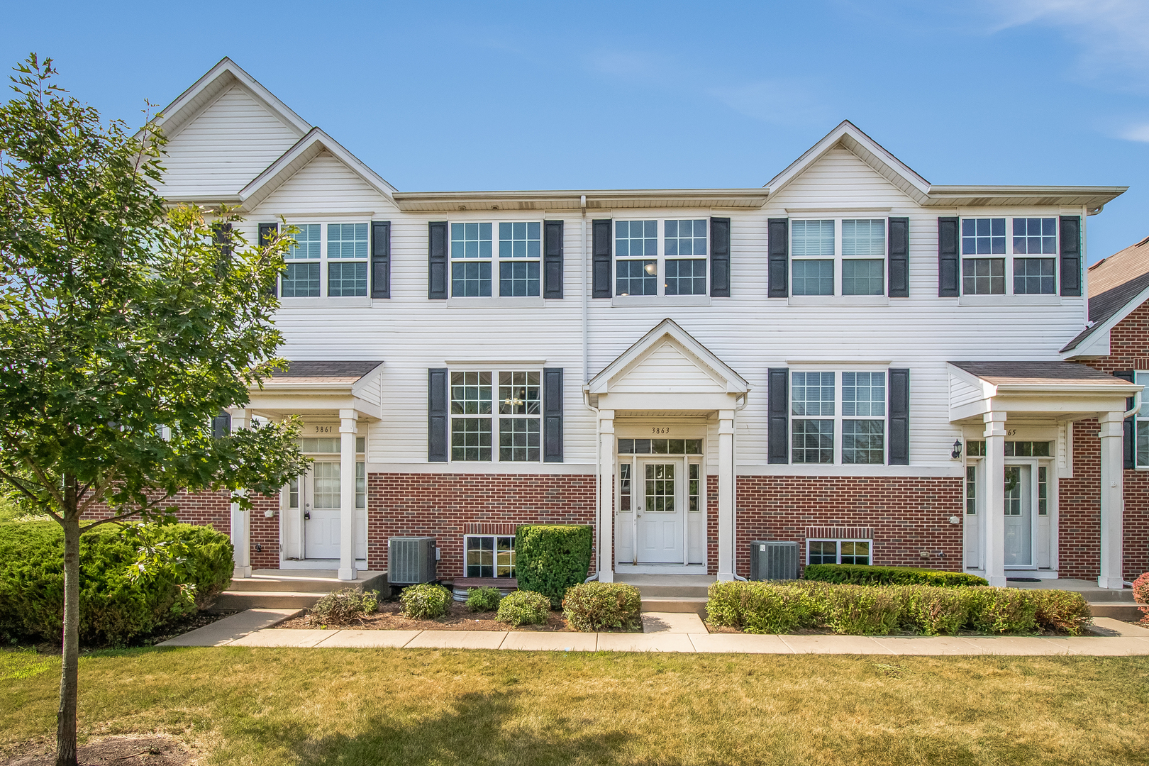 3863 Bailey Road Yorkville, IL 60560 - Photo 1 of 20 a front view of a house with a yard and potted plants
