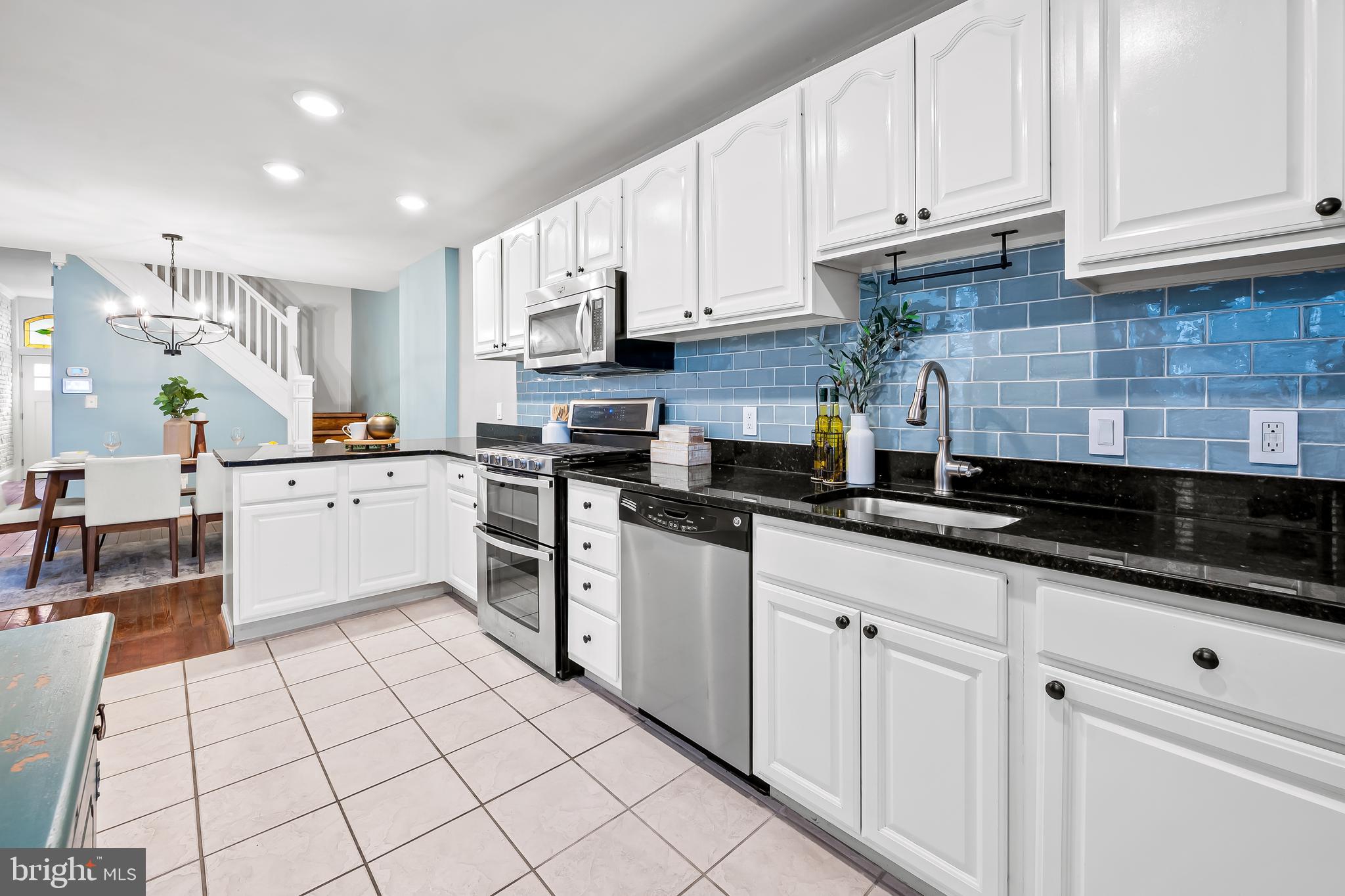 1045 Riverside Avenue Baltimore, MD 21230 - Photo 11 of 32 a kitchen with white cabinets and white appliances