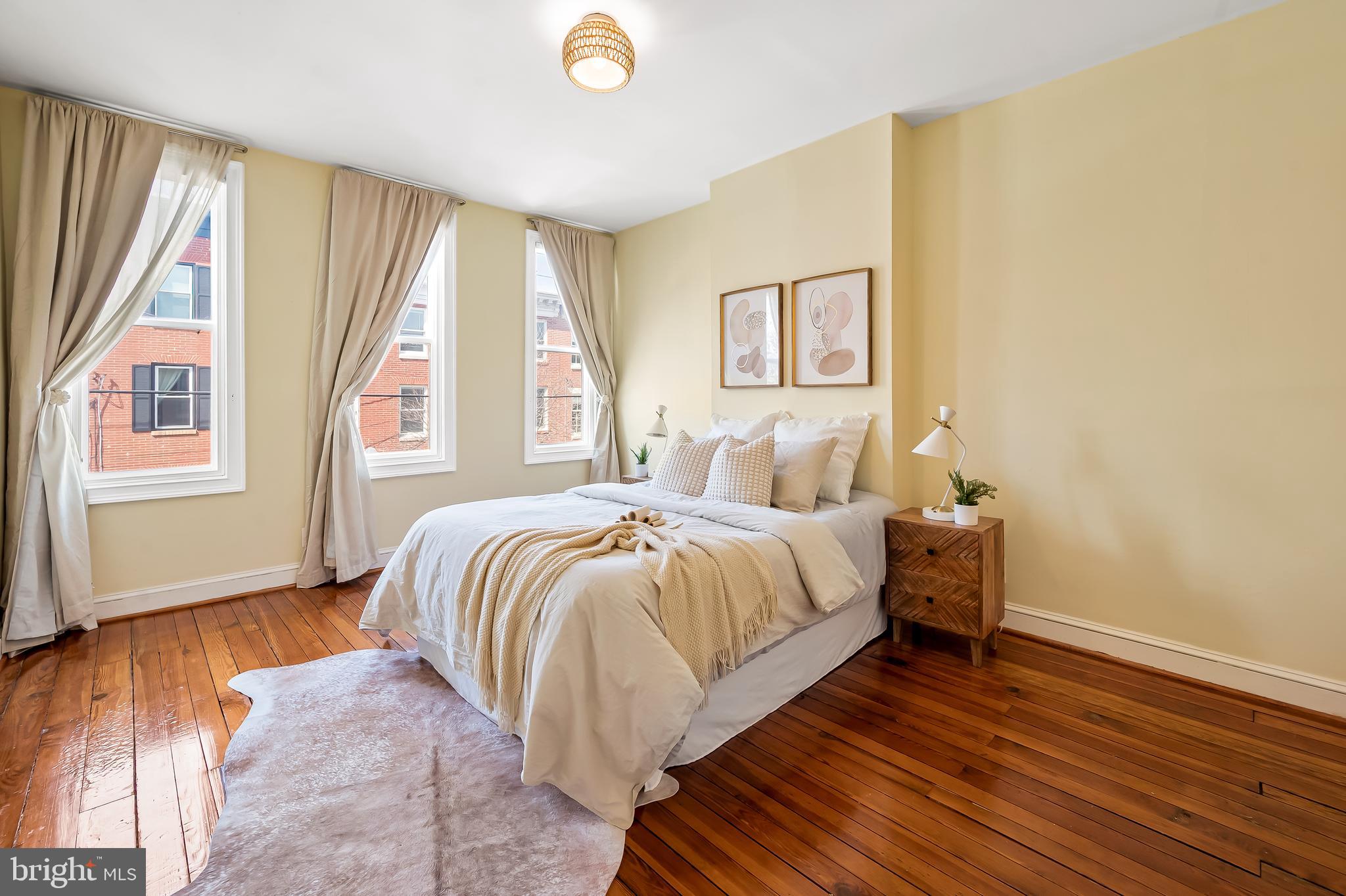 1045 Riverside Avenue Baltimore, MD 21230 - Photo 19 of 32 a bedroom with a bed and wooden floor