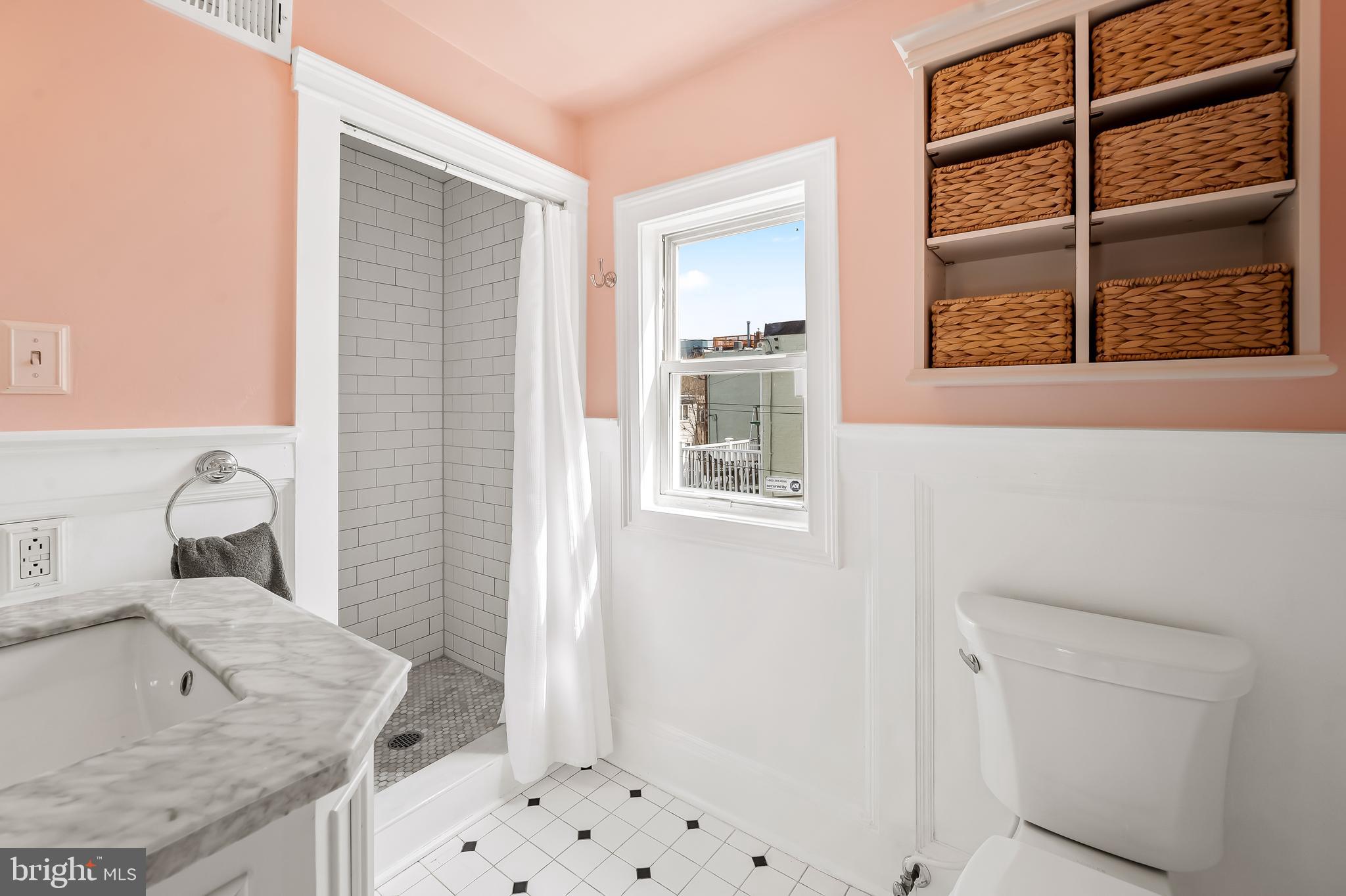 1045 Riverside Avenue Baltimore, MD 21230 - Photo 28 of 32 a bathroom with a granite countertop sink a toilet and shower