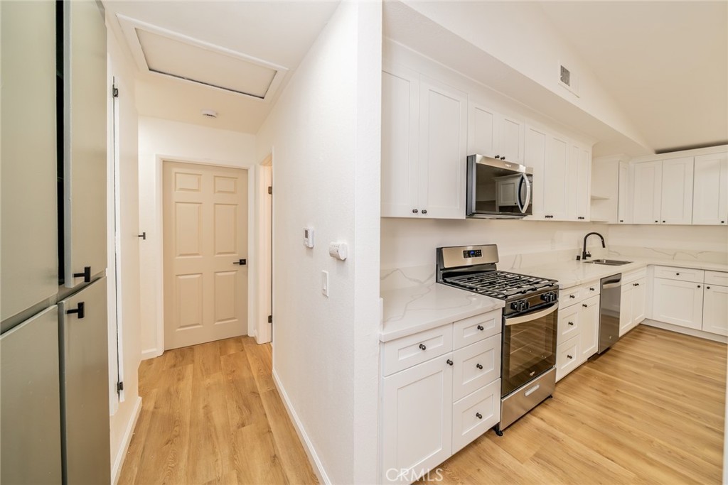 555 North Chestnut Avenue Rialto, CA 92376 - Photo 19 of 33 a kitchen with cabinets a sink and a stove