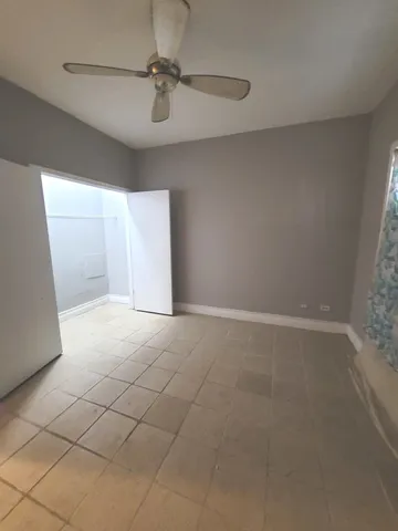 a view of an empty room and a window