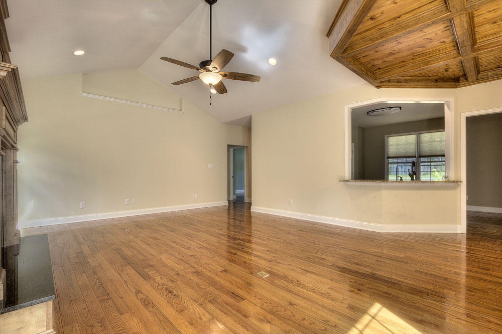 1400 Grimes Road Loudon, TN 37774 - Photo 12 of 32 a view of an empty room with wooden floor and a ceiling fan