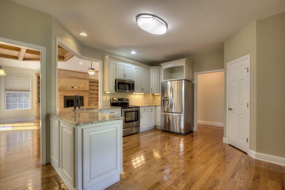 1400 Grimes Road Loudon, TN 37774 - Photo 16 of 32 a kitchen with stainless steel appliances kitchen island granite countertop a refrigerator and a stove top oven