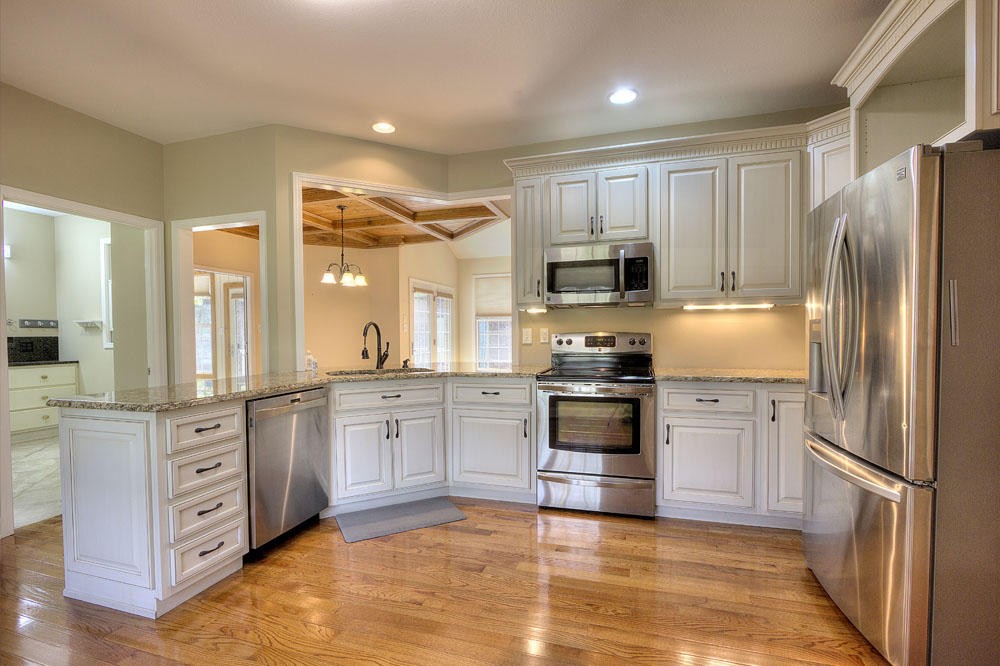 1400 Grimes Road Loudon, TN 37774 - Photo 17 of 32 a kitchen with granite countertop a refrigerator stove top oven and sink