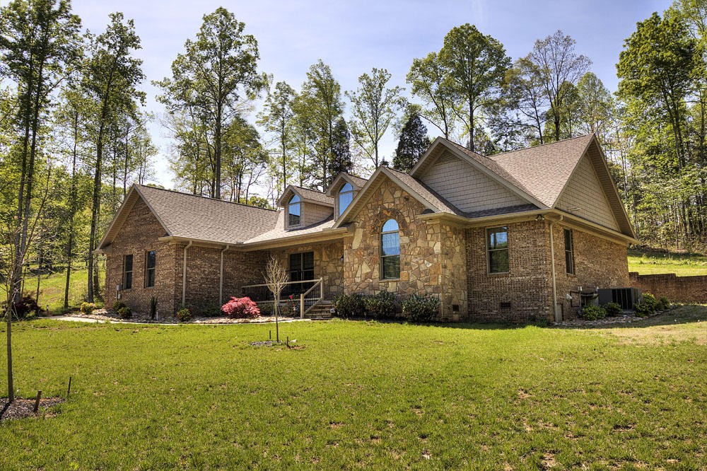 1400 Grimes Road Loudon, TN 37774 - Photo 2 of 32 a front view of house with an outdoor space and seating