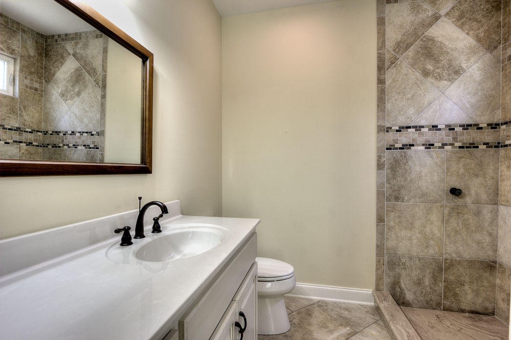 1400 Grimes Road Loudon, TN 37774 - Photo 22 of 32 a bathroom with a sink and mirror with toilet