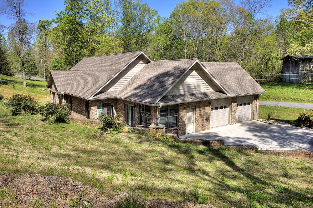 1400 Grimes Road Loudon, TN 37774 - Photo 3 of 32 a house with green field in front of it