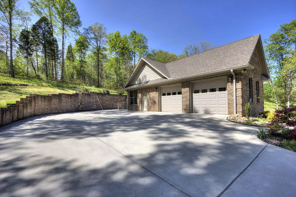 1400 Grimes Road Loudon, TN 37774 - Photo 8 of 32 a view of a house with a backyard and a garage