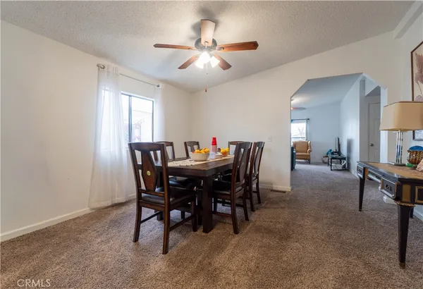 a view of a dining room with furniture and a chandelier