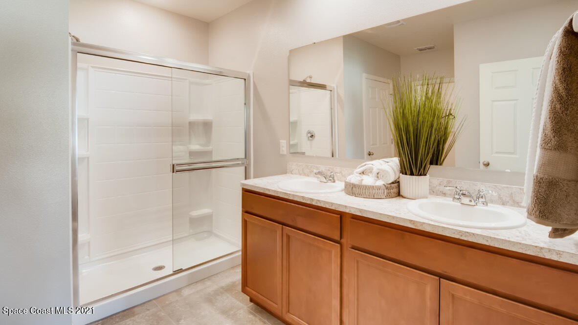 519 Old Country Rd S East Palm Bay, FL 32909 - Photo 6 of 29 a bathroom with a granite countertop sink mirror and double