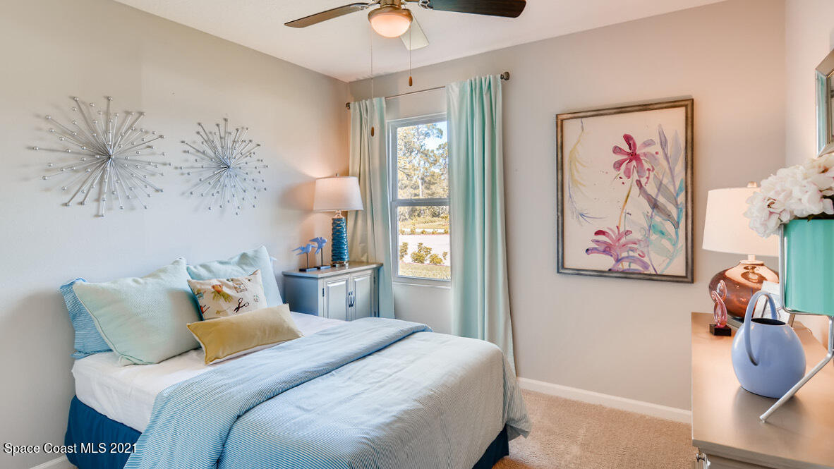 519 Old Country Rd S East Palm Bay, FL 32909 - Photo 7 of 29 a bedroom with a bed and a painting on the wall