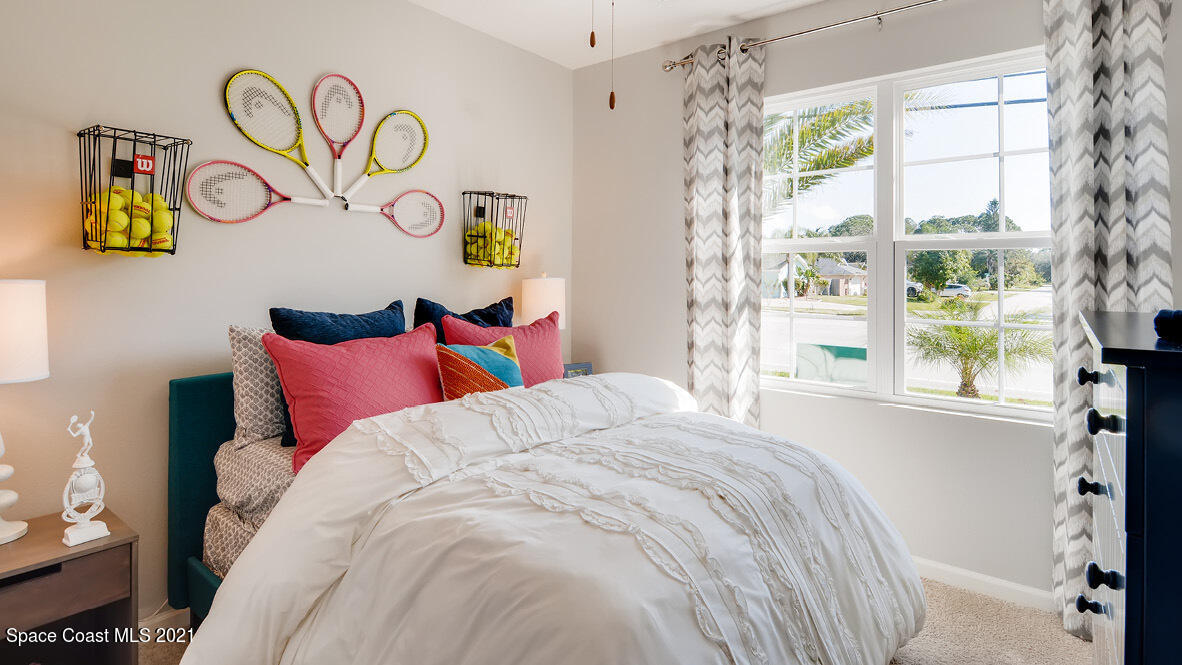 519 Old Country Rd S East Palm Bay, FL 32909 - Photo 8 of 29 a bedroom with a bed and a window