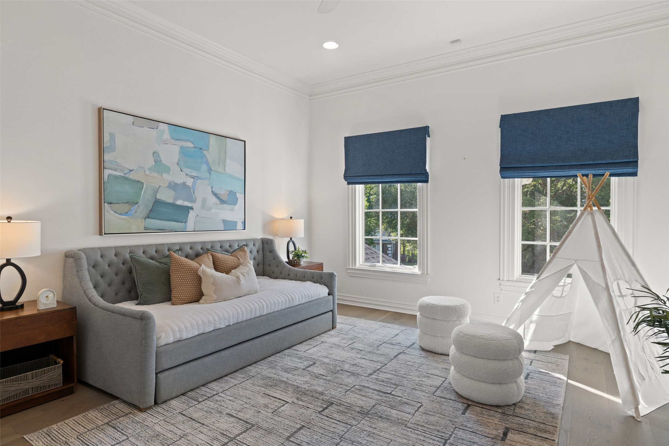 4201 Green Cliffs Road Austin, TX 78746 - Photo 25 of 40 Sunlight fills this spacious guest bedroom, where crisp white walls and warm hardwood floors create an open, relaxing space for visitors to settle in and recharge