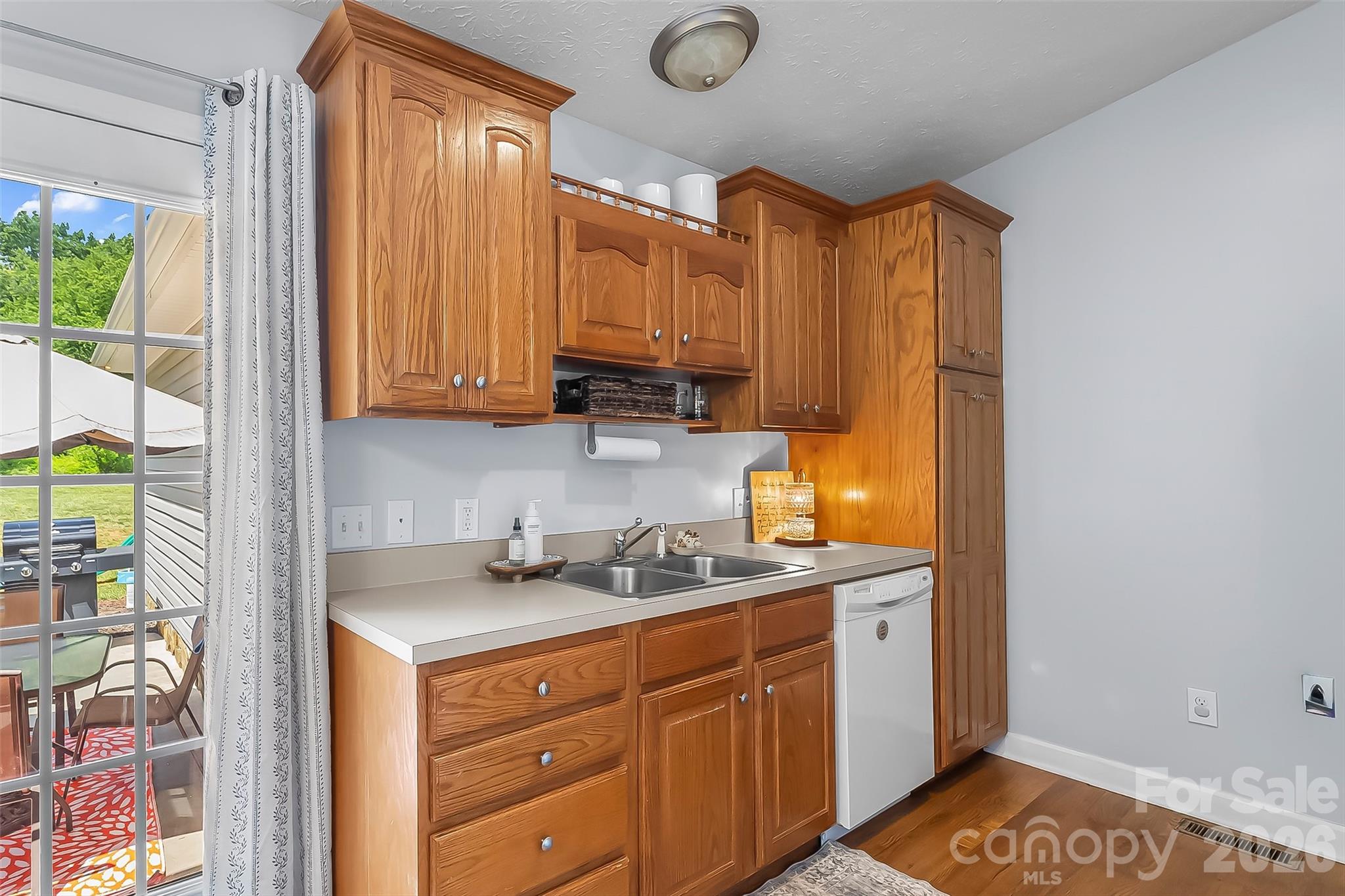 1498 Salem Road Morganton, NC 28655 - Photo 15 of 32 a kitchen with stainless steel appliances granite countertop a sink a stove a refrigerator a counter space and cabinets