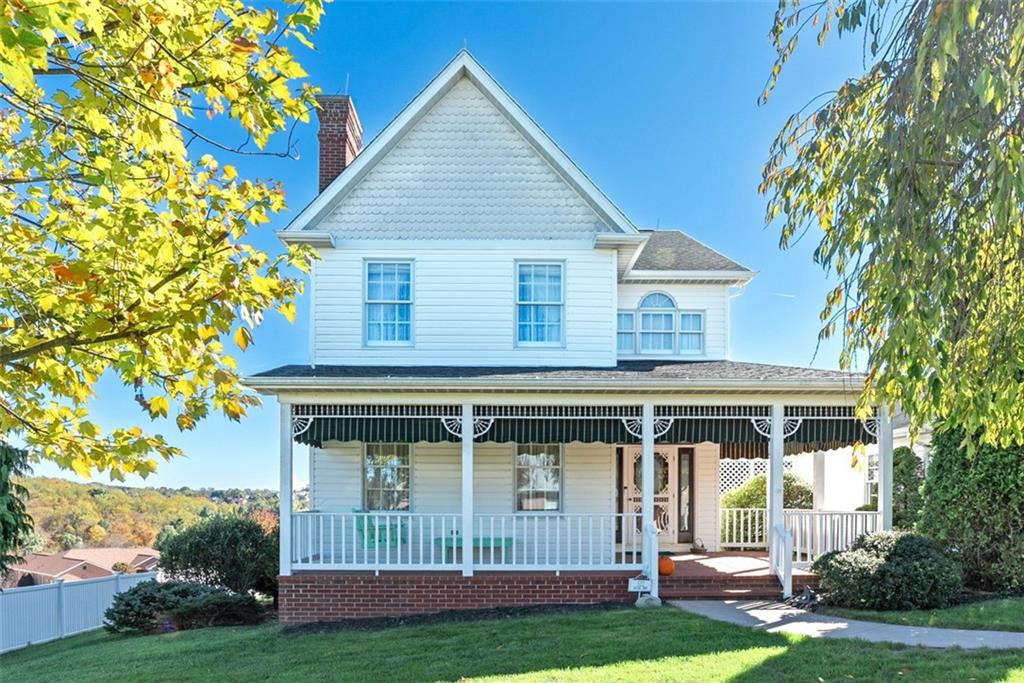 a view of house with yard and sitting area