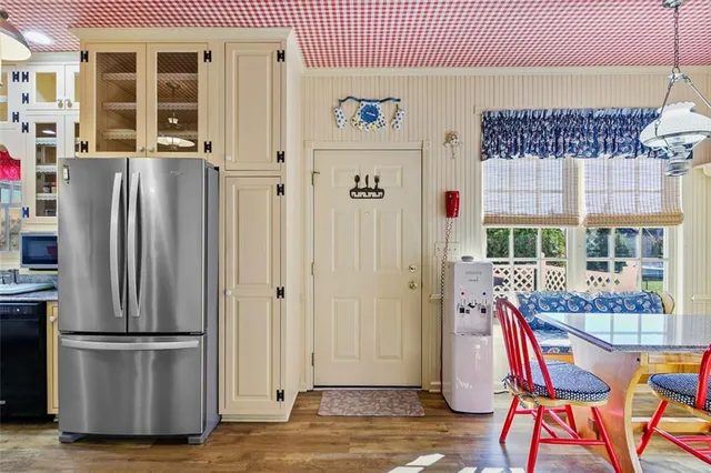 a view of a dining room with furniture a chandelier and wooden floor