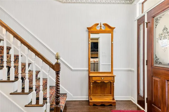 a view of staircase with wooden floor and a window
