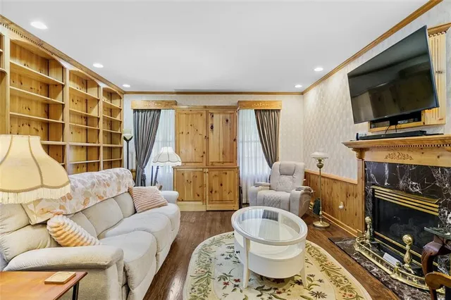 a living room with fireplace furniture and a flat screen tv