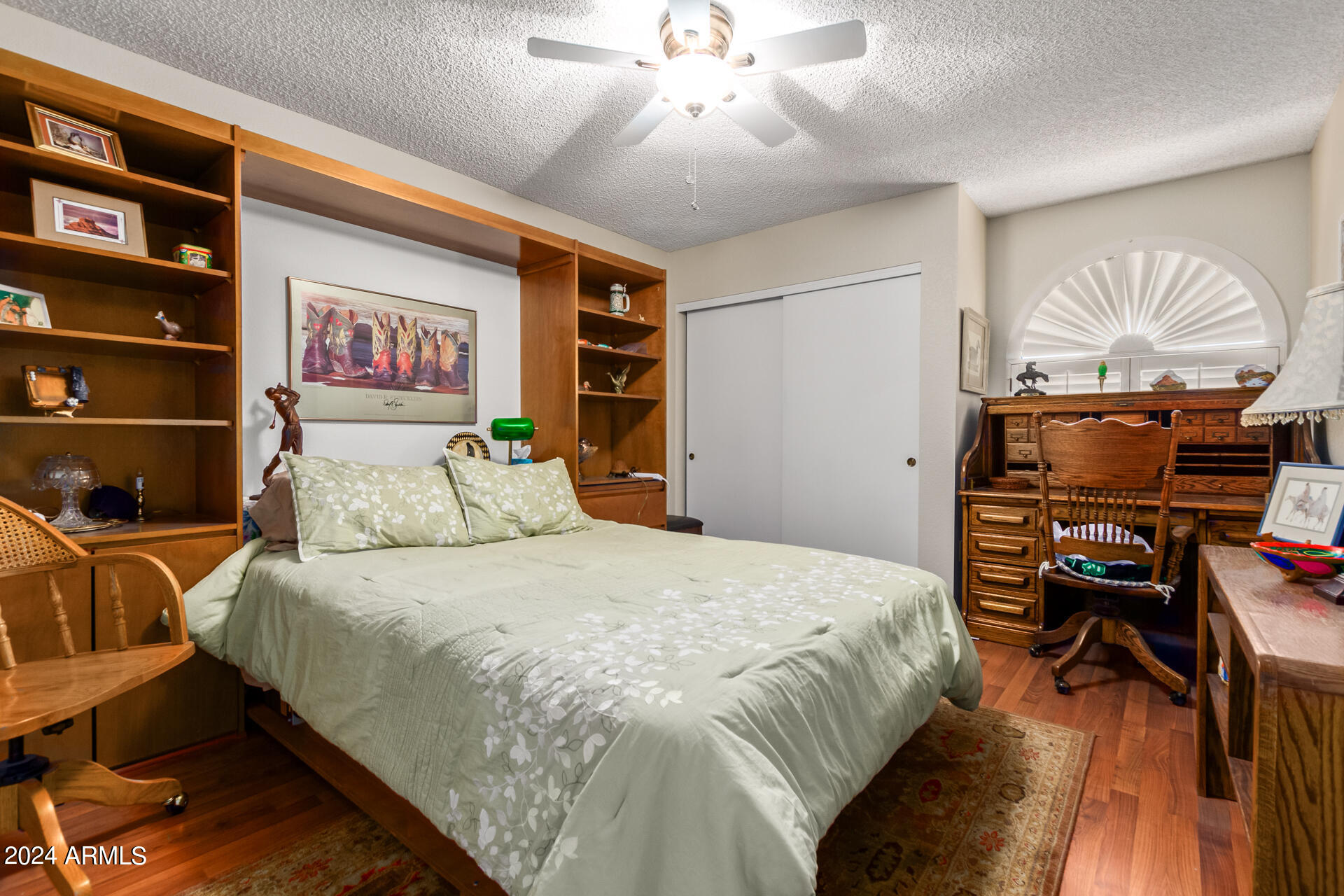 1021 South Greenfield Road, Unit 1058 Mesa, AZ 85206 - Photo 11 of 14 a bedroom with a bed and a chandelier