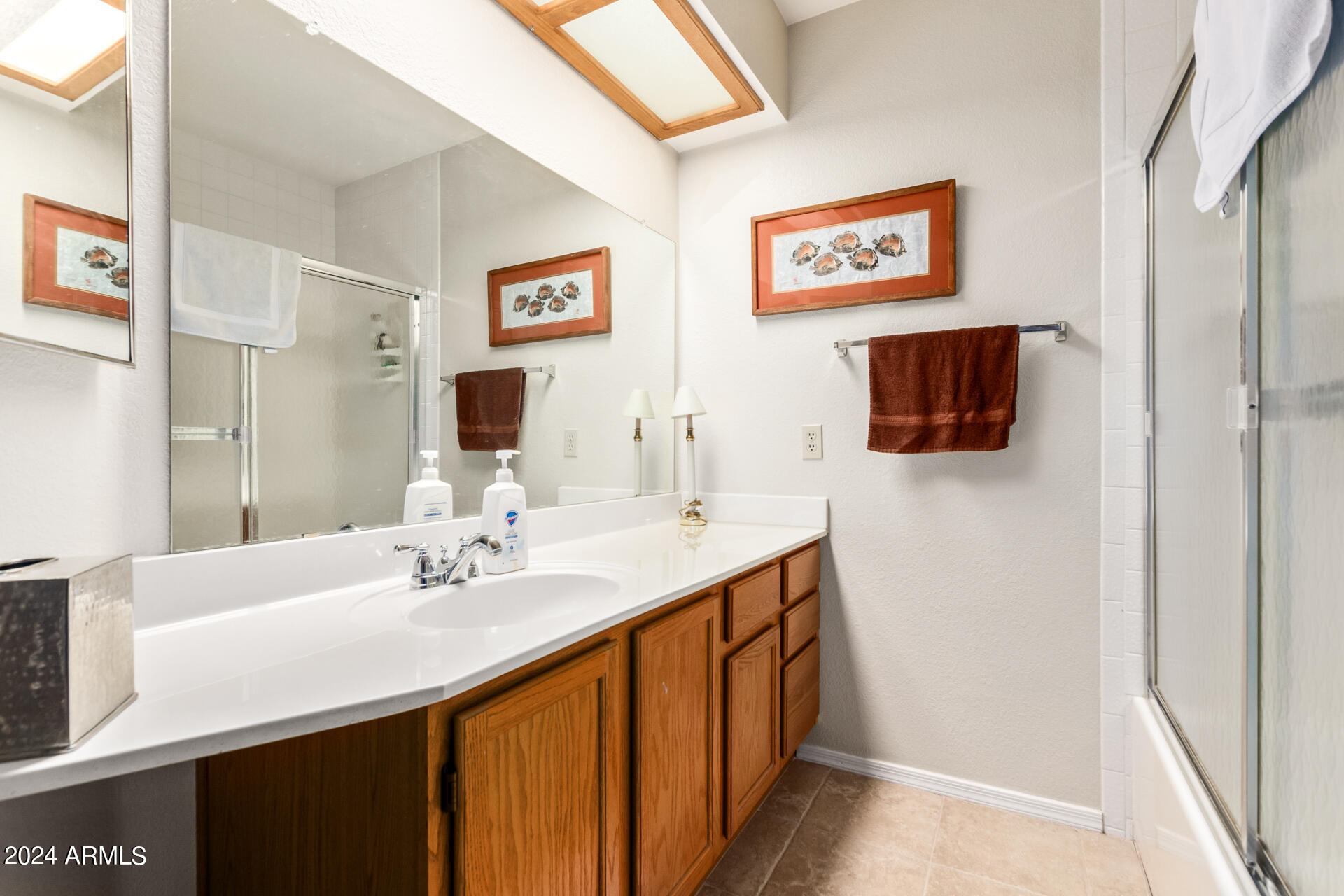 1021 South Greenfield Road, Unit 1058 Mesa, AZ 85206 - Photo 12 of 14 a bathroom with a sink and a mirror