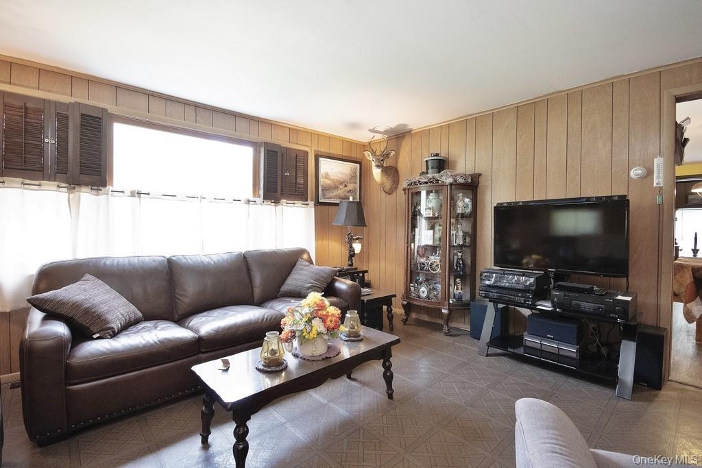 169 Mitchell Pond E Road Cochecton, NY 12726 - Photo 15 of 33 a living room with furniture and a flat screen tv