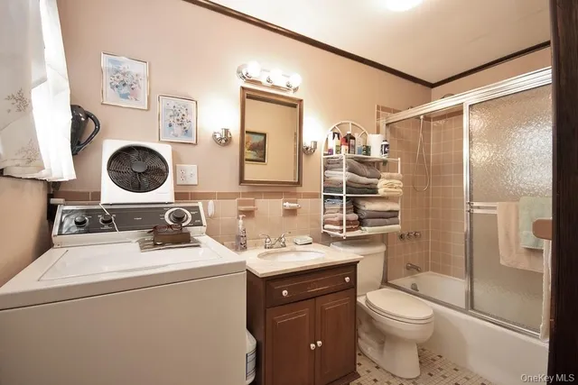 a bathroom with a toilet a sink and a mirror