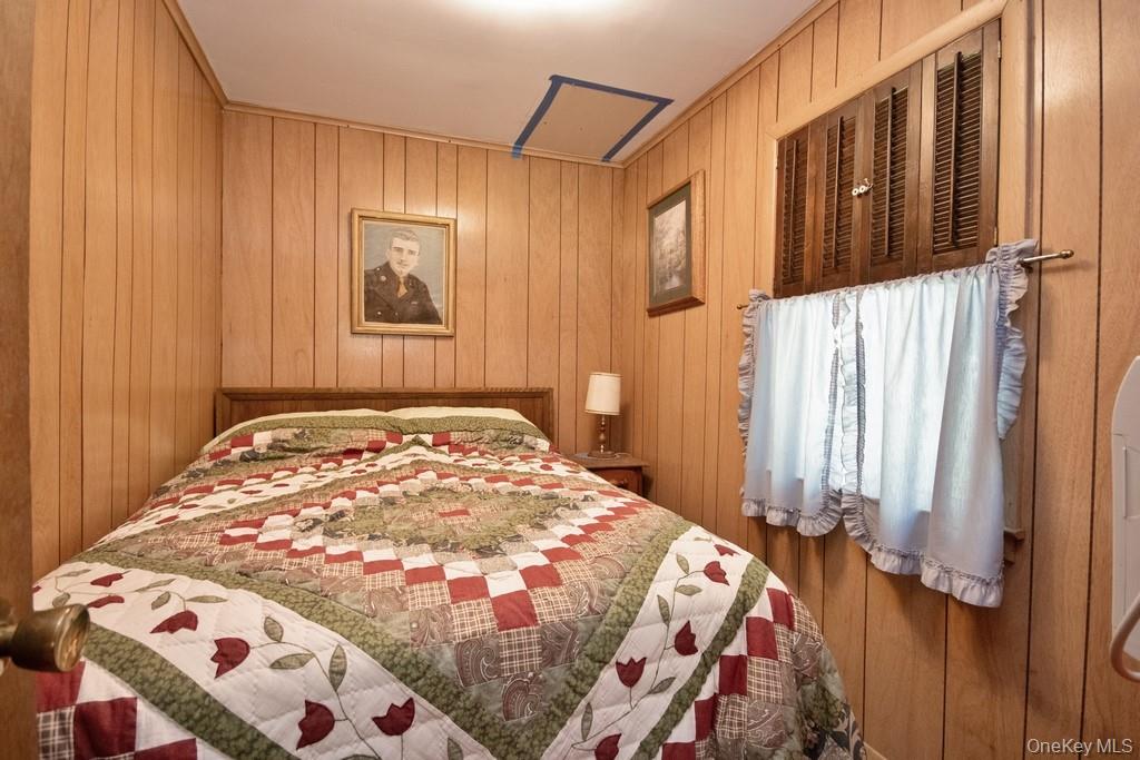 169 Mitchell Pond E Road Cochecton, NY 12726 - Photo 18 of 33 a bedroom with a bed and a window