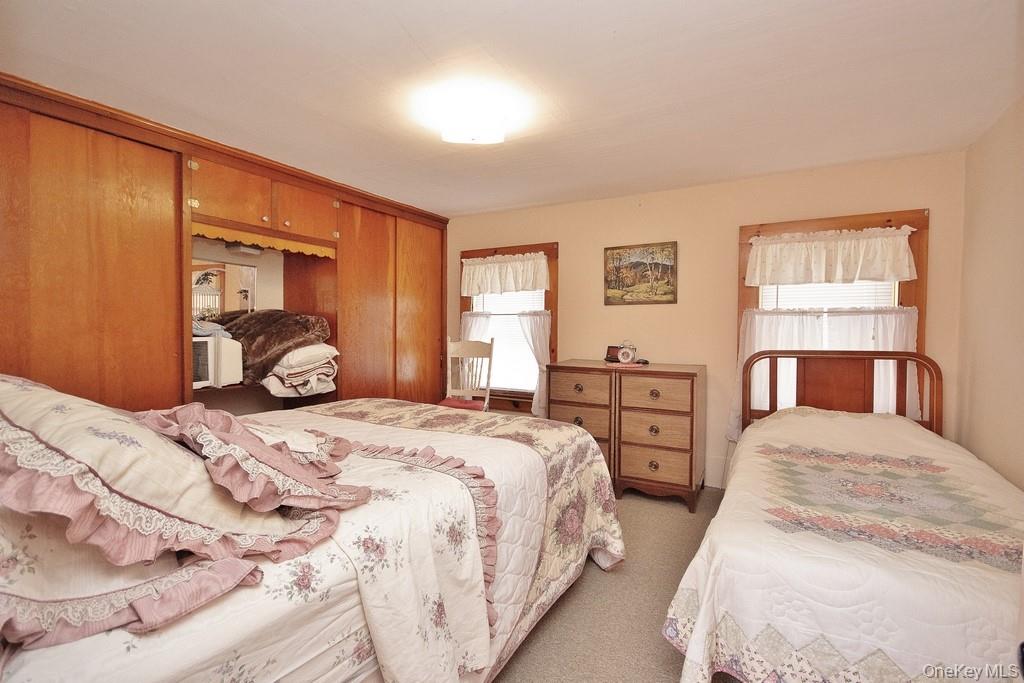 169 Mitchell Pond E Road Cochecton, NY 12726 - Photo 21 of 33 a bedroom with two beds and a dresser