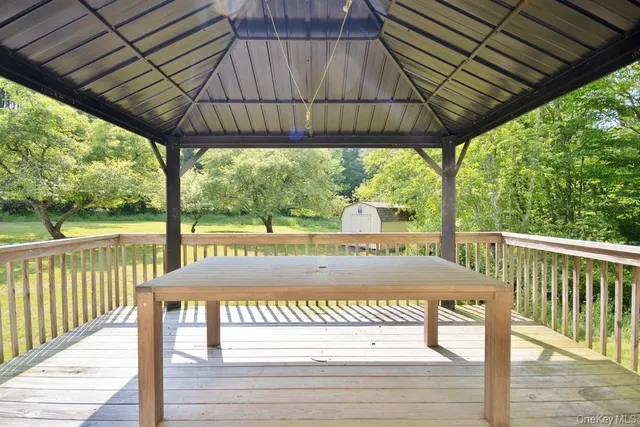 a view of porch with a table chairs and a umbrella