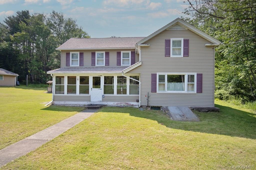 169 Mitchell Pond E Road Cochecton, NY 12726 - Photo 4 of 33 a front view of a house with yard and green space