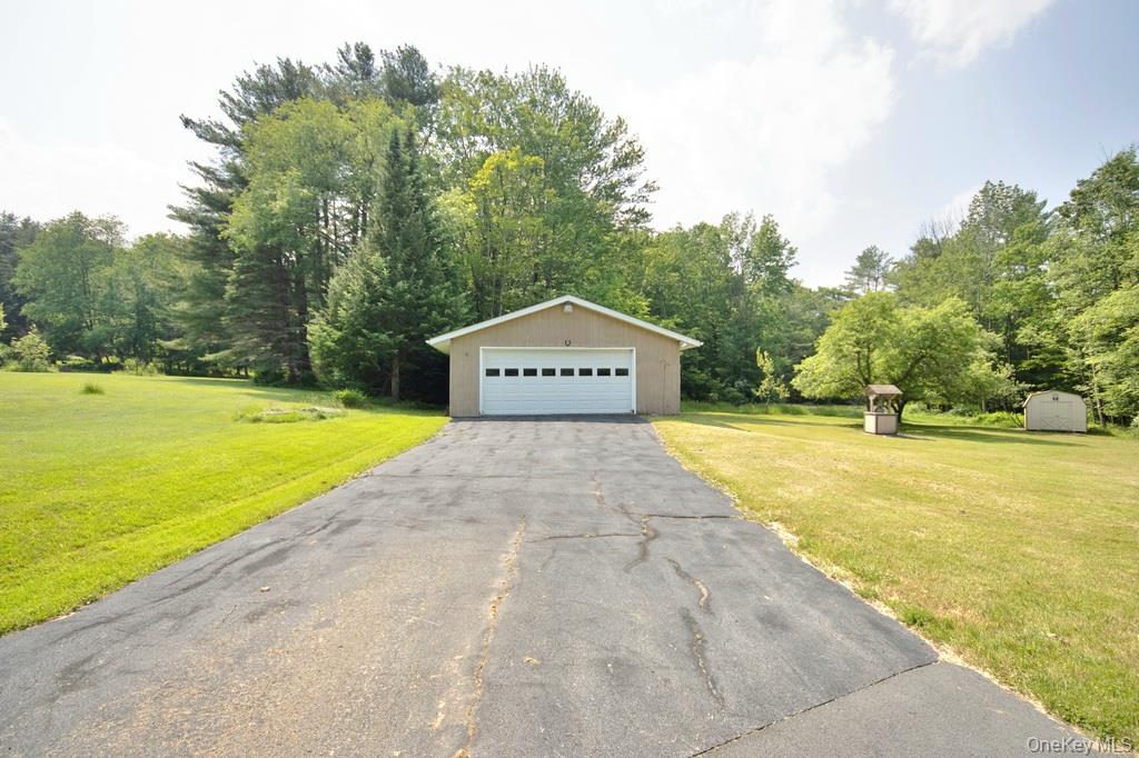 169 Mitchell Pond E Road Cochecton, NY 12726 - Photo 5 of 33 a view of a swimming pool with an outdoor space and seating area