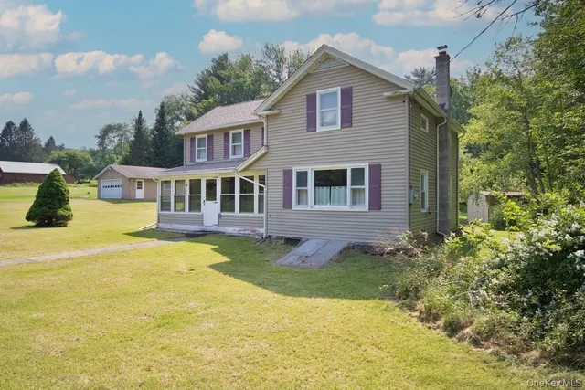 a front view of a house with yard and swimming pool
