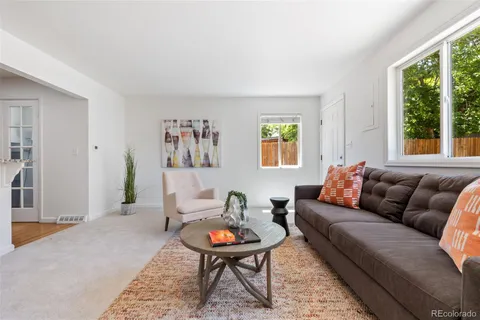 a living room with furniture a rug and a large window