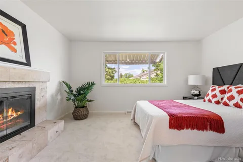 a bedroom with a bed and a fireplace