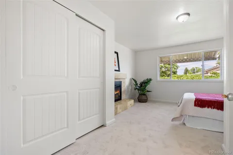 a hallway with a couch and a potted plant