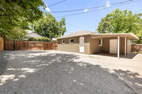 a backyard of a house with large trees and outdoor space