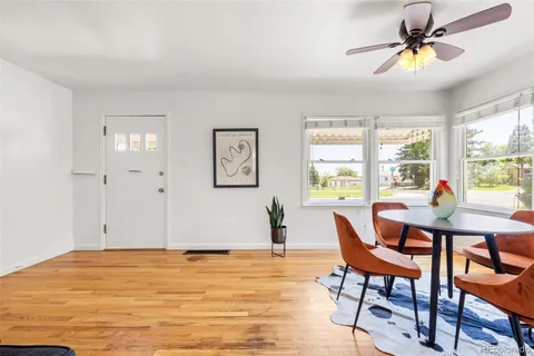 a living room with furniture a window and a ceiling fan